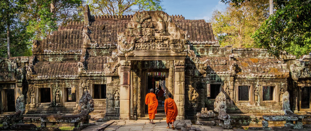 Monk walking in to visit the Angkor Wat temple.